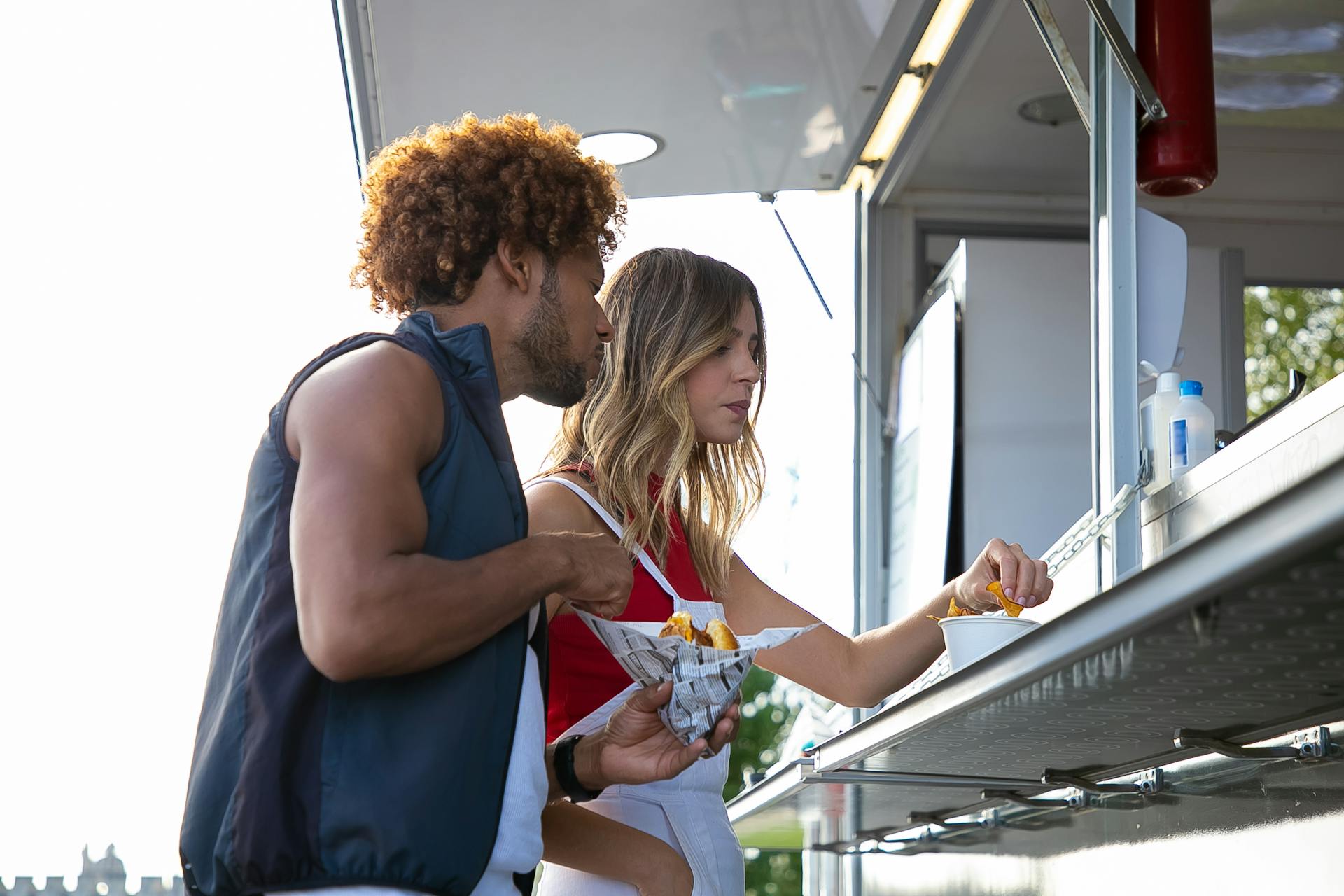 Multiethnic couple having lunch at street food truck