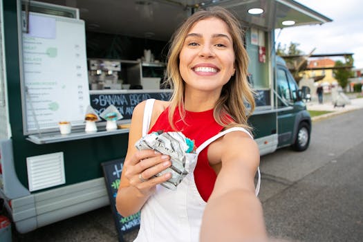 Happy woman in casual wear taking a selfie with street food truck in the background.
