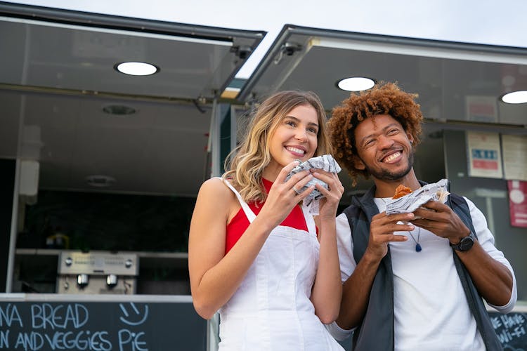 Happy Multiethnic Friends Eating Hamburgers Near Food Truck