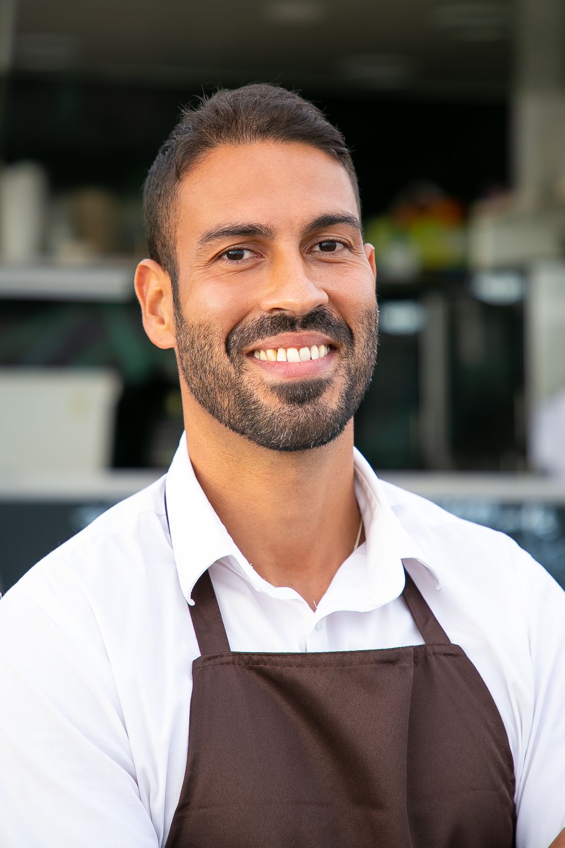 A server and guests in a busy, welcoming restaurant