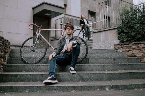 Two Men Posing with their Bicycles on Concrete Stairs