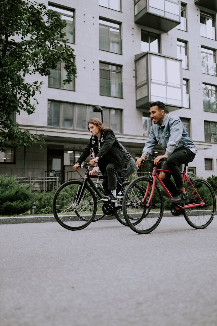 Two Men Riding Their Bicycles In The City