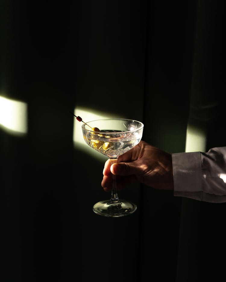 A Person Holding A Cocktail Drink