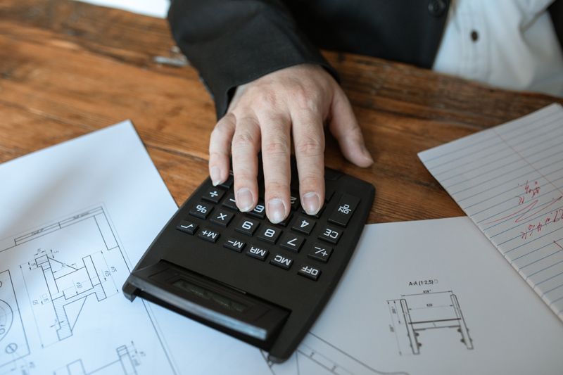 Calculator and working papers on a desk — photo by RDNE Stock project on Pexels