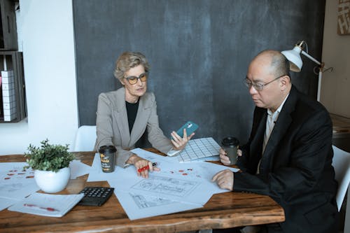 A Woman and a Man Working Together in an Office 
