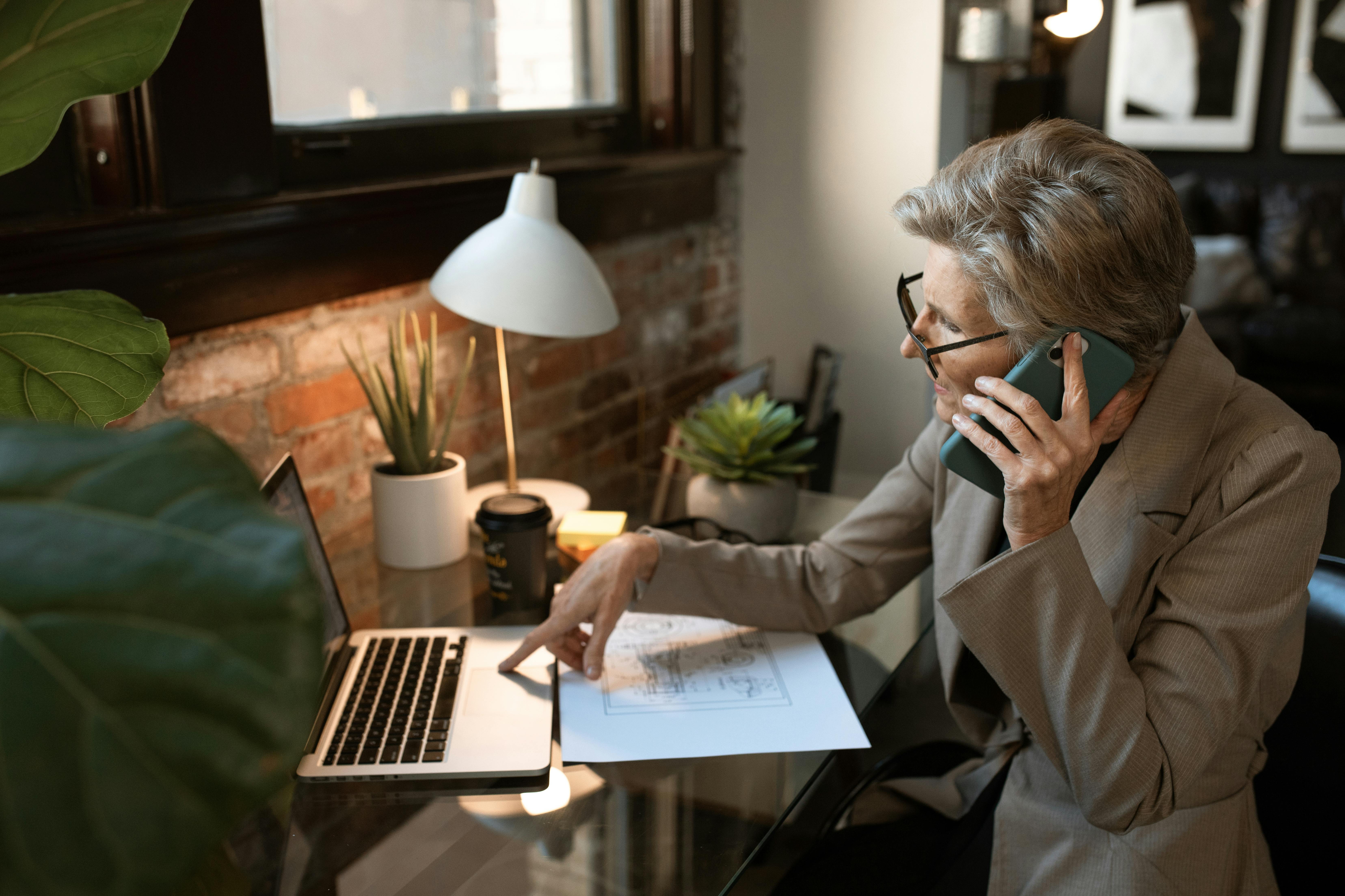 Businesswoman on phone while working at computer