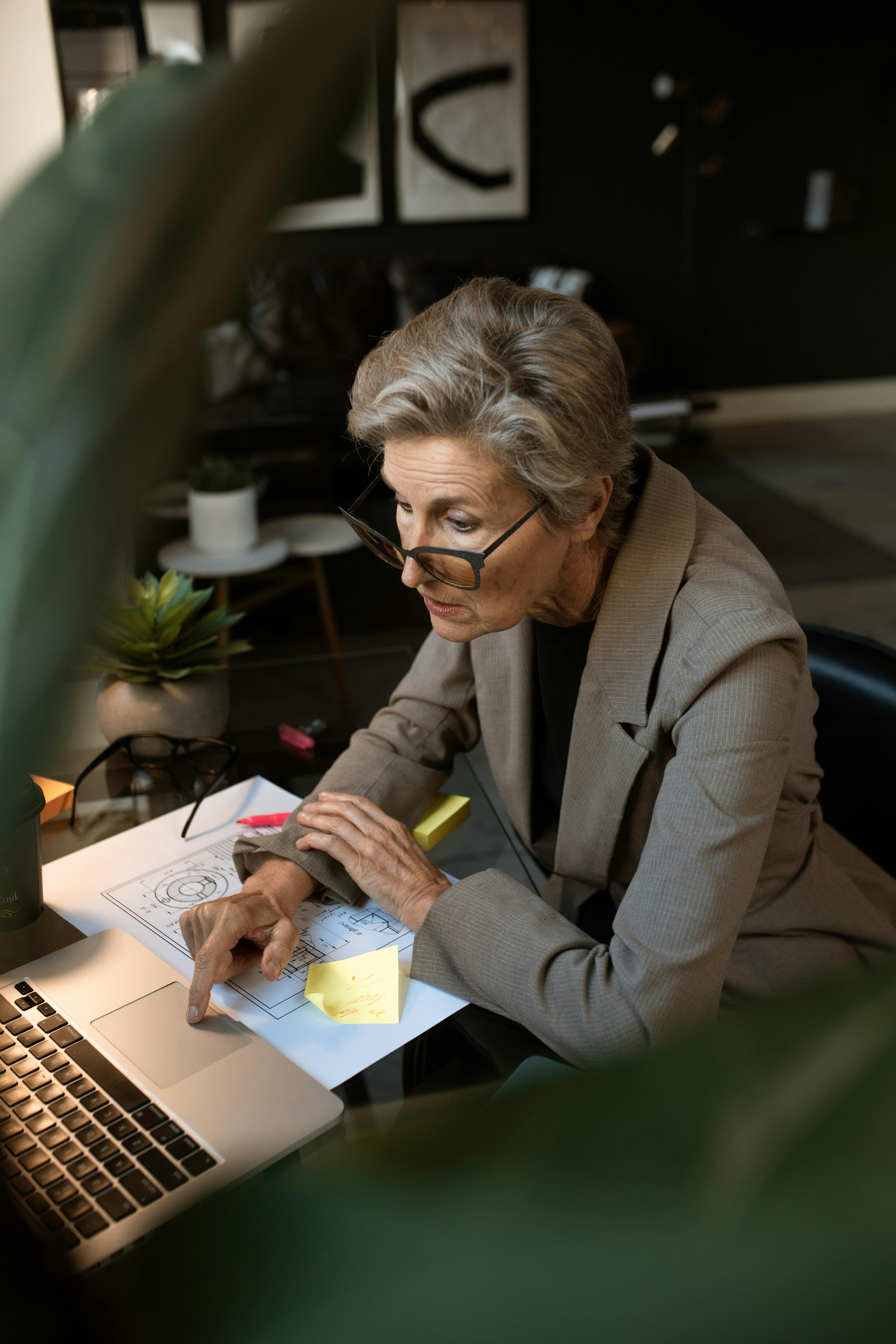 woman in gray blazer sitting on chair