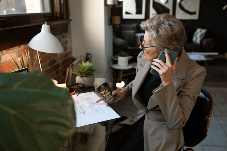 Woman In Brown Blazer Talking On The Phone