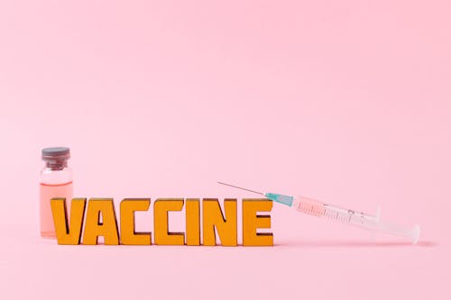 Free Covid Vaccine on Pink Surface Stock Photo