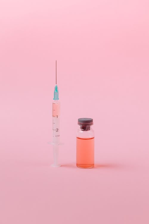 Free Vaccine on Pink Surface Stock Photo