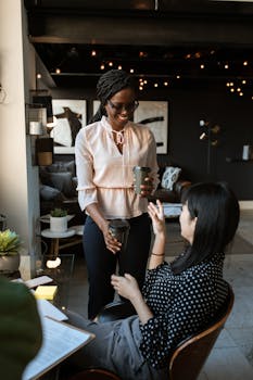 Two women collaborating in a stylish, modern office. Empowerment and teamwork.