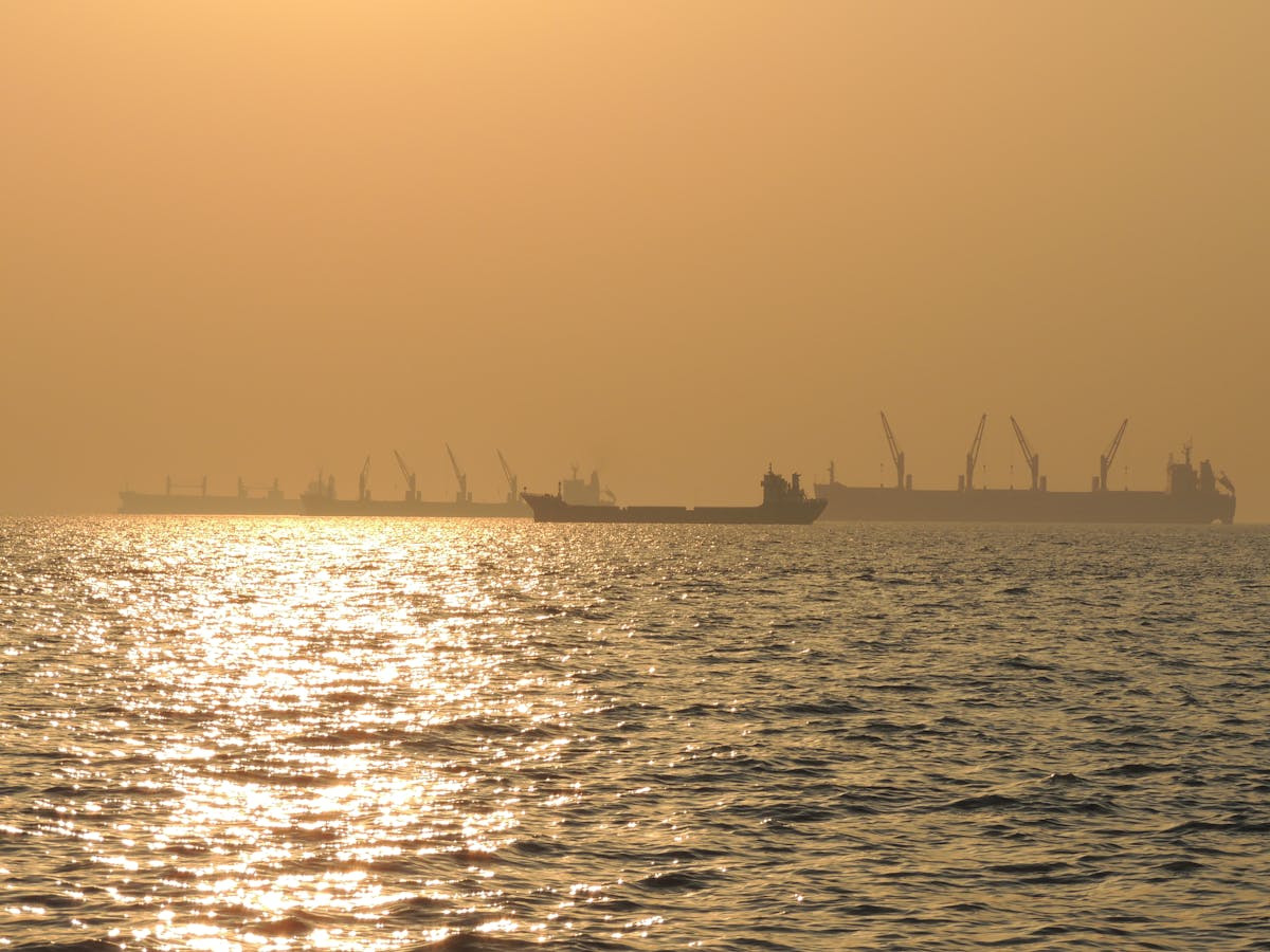 A person holding an insulin or GLP‑1 injection pen above a table with fresh vegetables