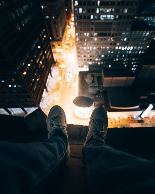 Free Experience the thrilling view from a rooftop in downtown Chicago at night, showcasing city lights and urban architecture. Stock Photo