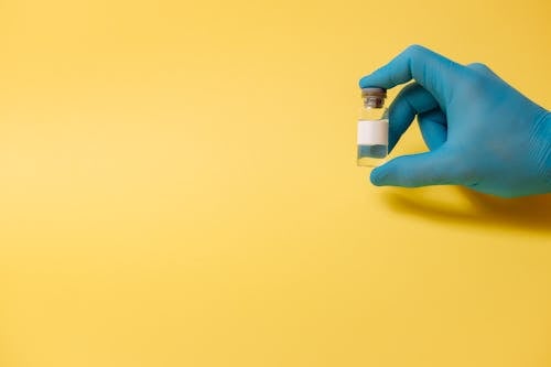 Free Person Holding a Vial Stock Photo