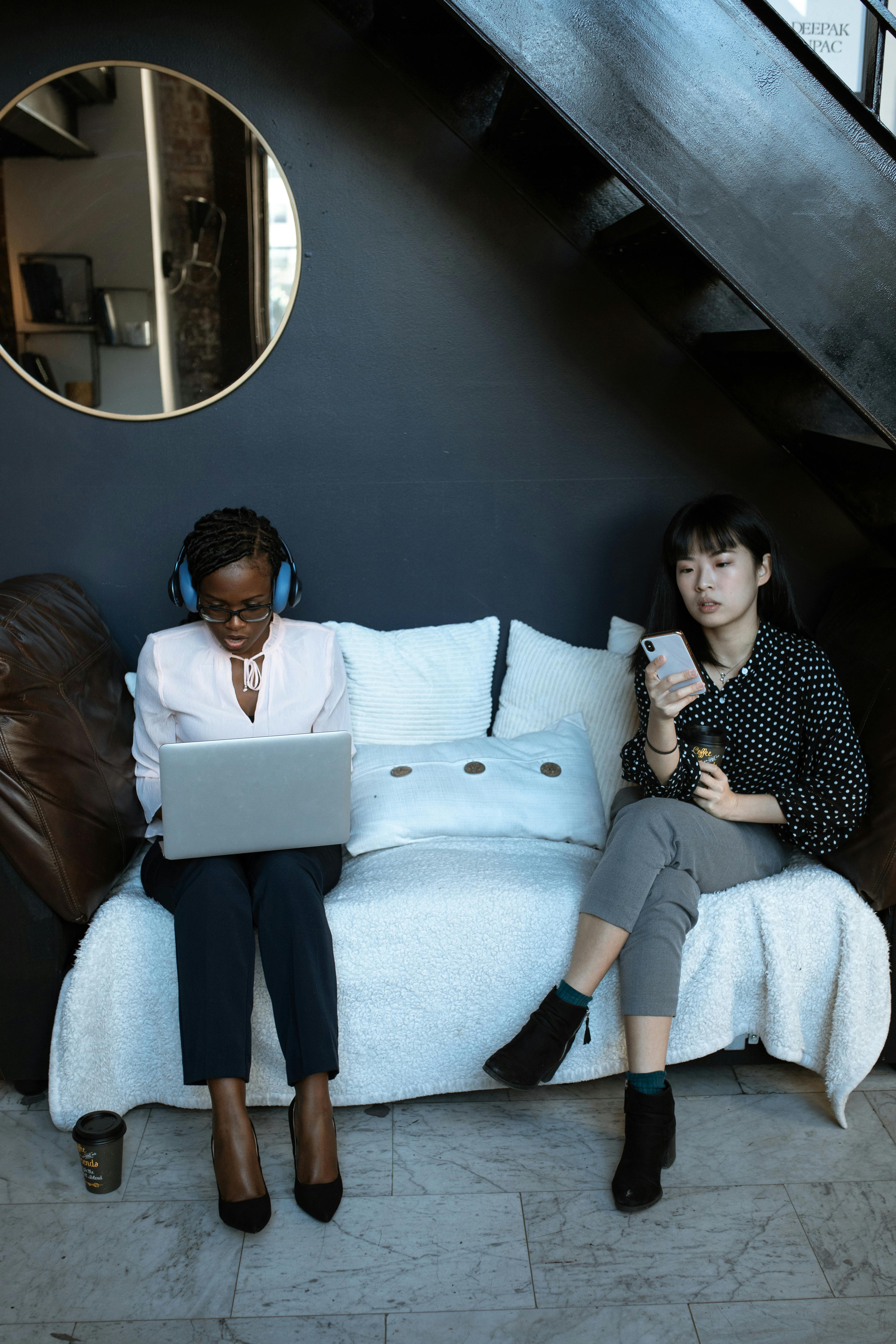 woman in white long sleeve shirt and black and white pants sitting on white couch