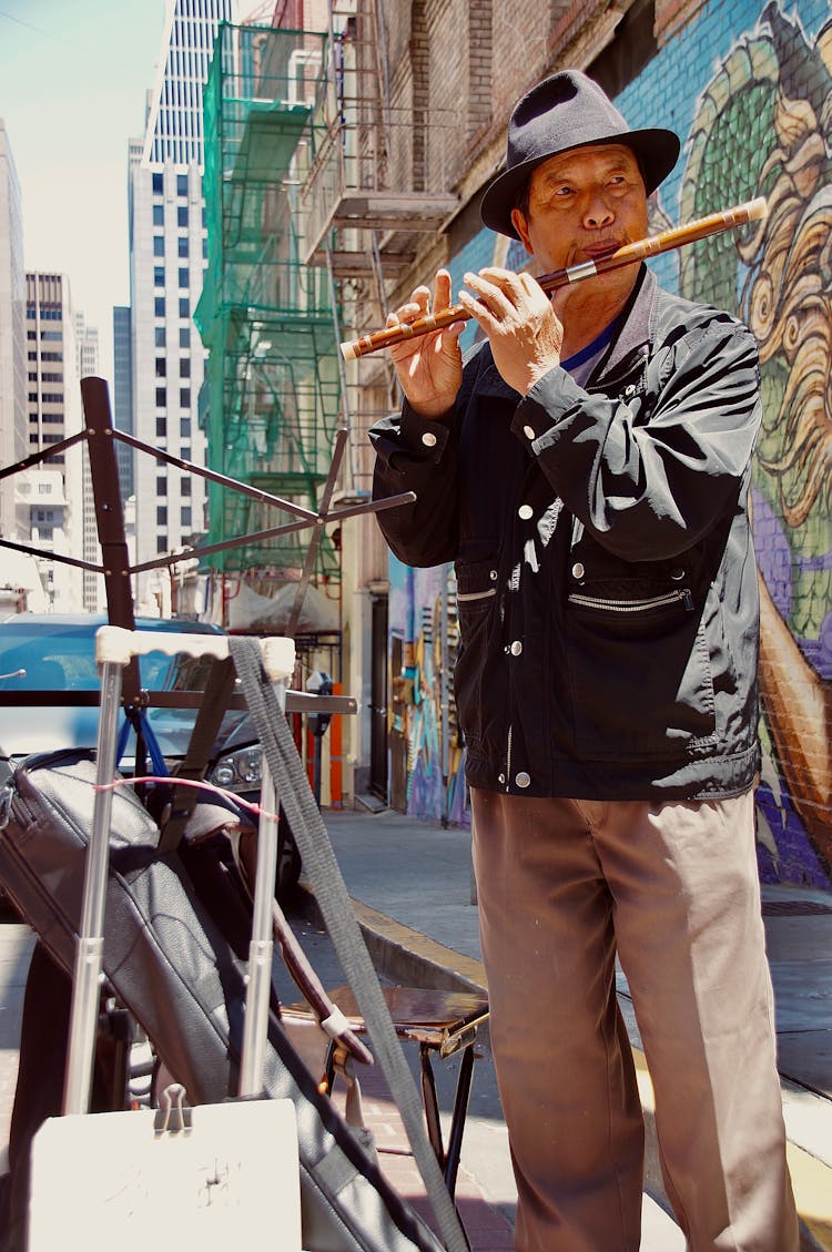 Man Playing On Reed Pipe On Street