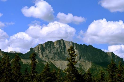 Majestic view of the Rocky Mountains under a vibrant blue sky in Golden, British Columbia.