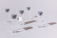 Five Clear Glass Bottles on White Table