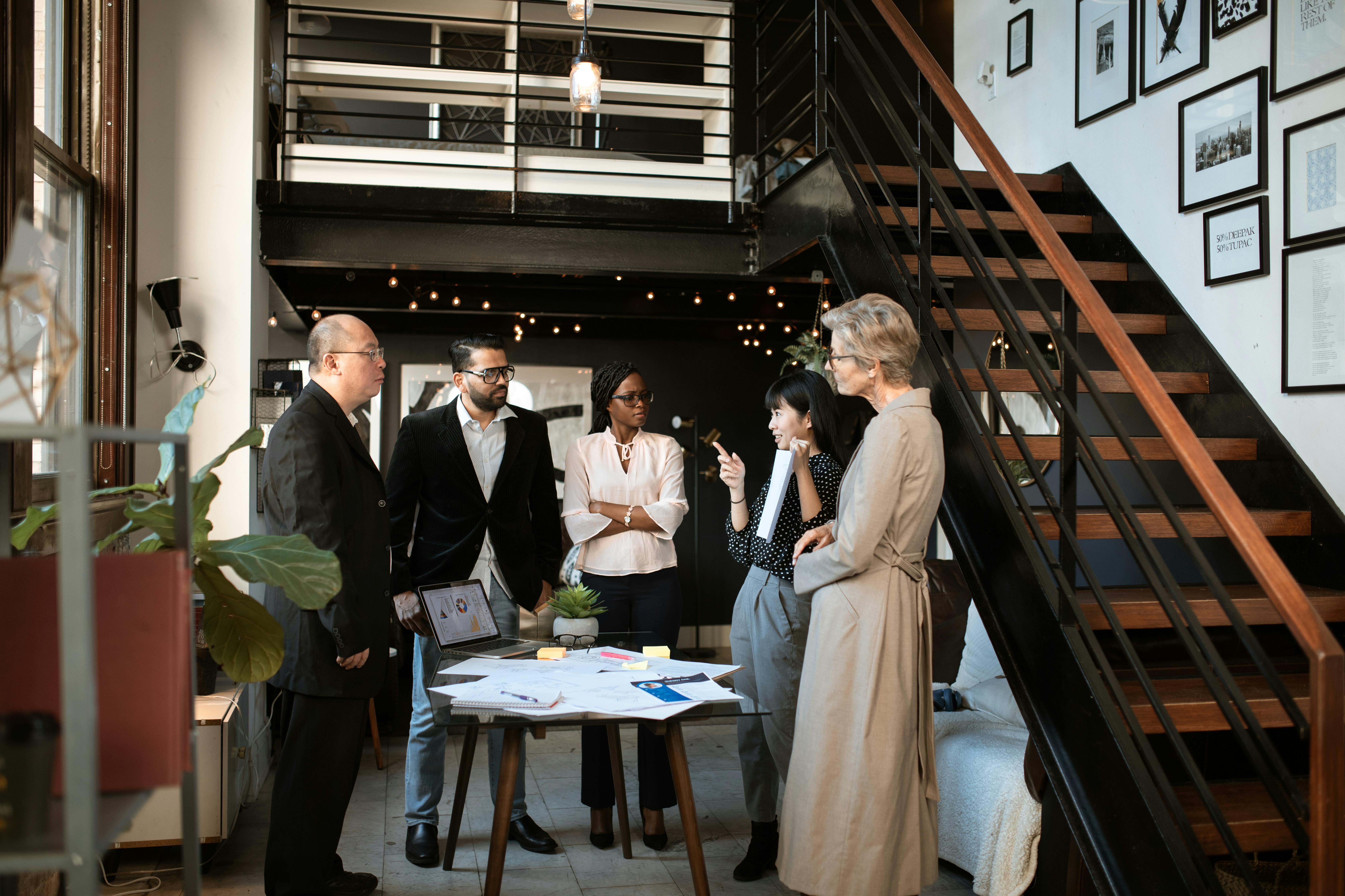 man in black suit jacket standing beside woman in beige dress