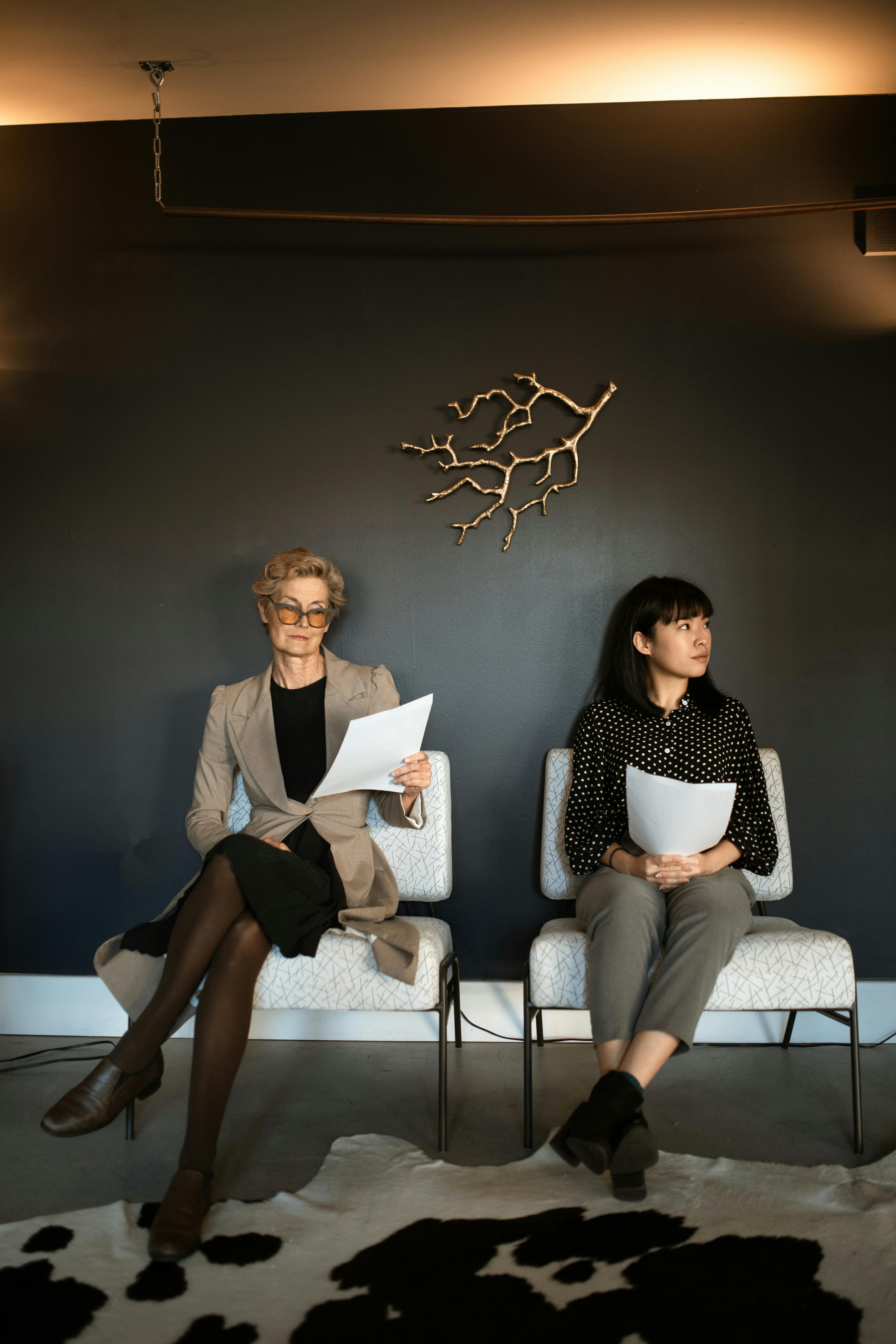 women sitting on chairs