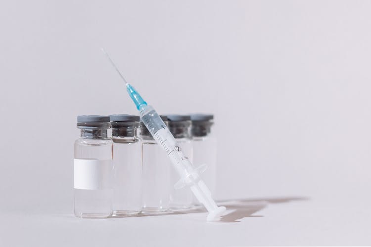 Covid Vaccine Bottles And Syringe