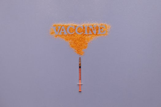 一张概念图像：灰色背景上，橙色粉末中带有“疫苗”字样的注射器