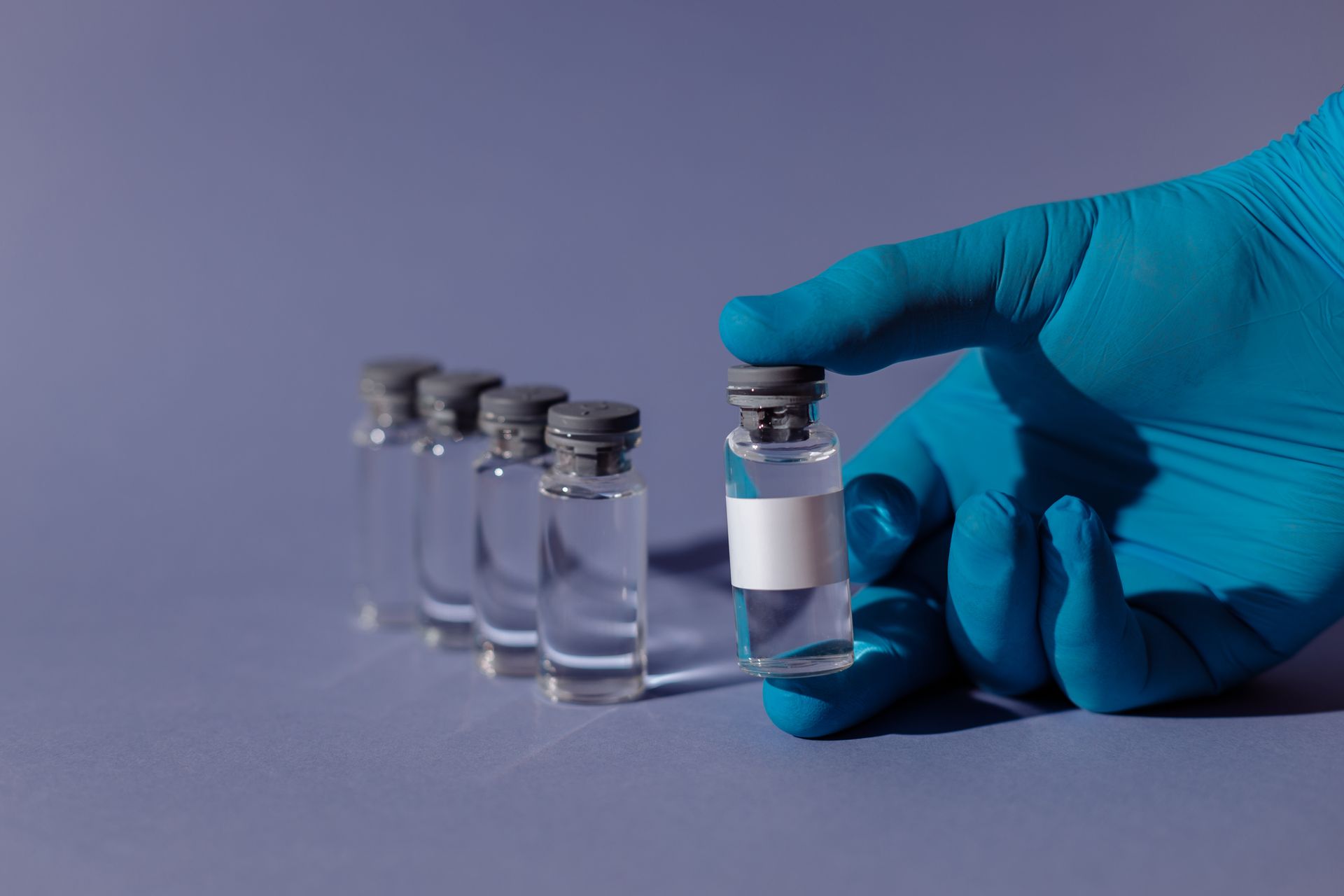 Vaccine vials and research equipment in a laboratory