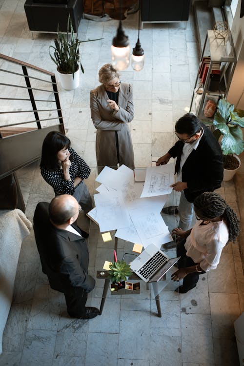 An image of people standing around a table in an office in Dallas