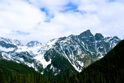 Majestic snowy mountains under a blue sky in Golden, British Columbia, Canada.