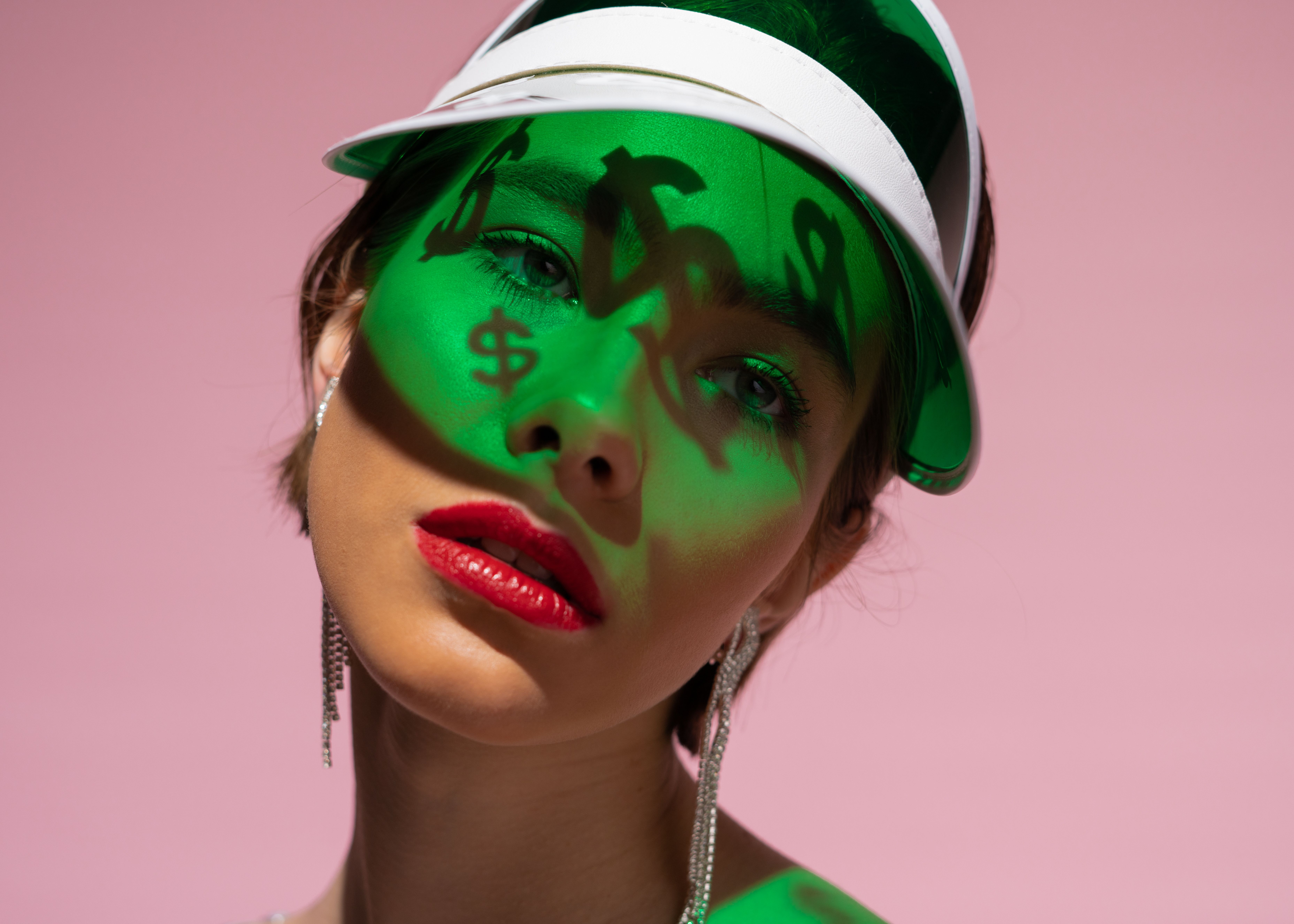 Woman using LED light therapy face mask at home during evening skincare routine
