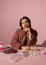 Woman in Brown Sweater Sitting at the Table