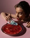Woman Pulling a Money Out of a Jelly