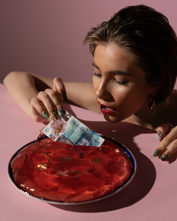 Woman Pulling A Money Out Of A Jelly