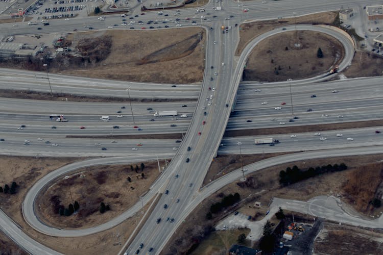 Cars Driving On Asphalt Winding Road Of Freeway