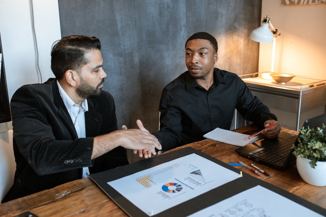 Free Man in Black Dress Shirt Sitting Beside Man in Black Dress Shirt Stock Photo