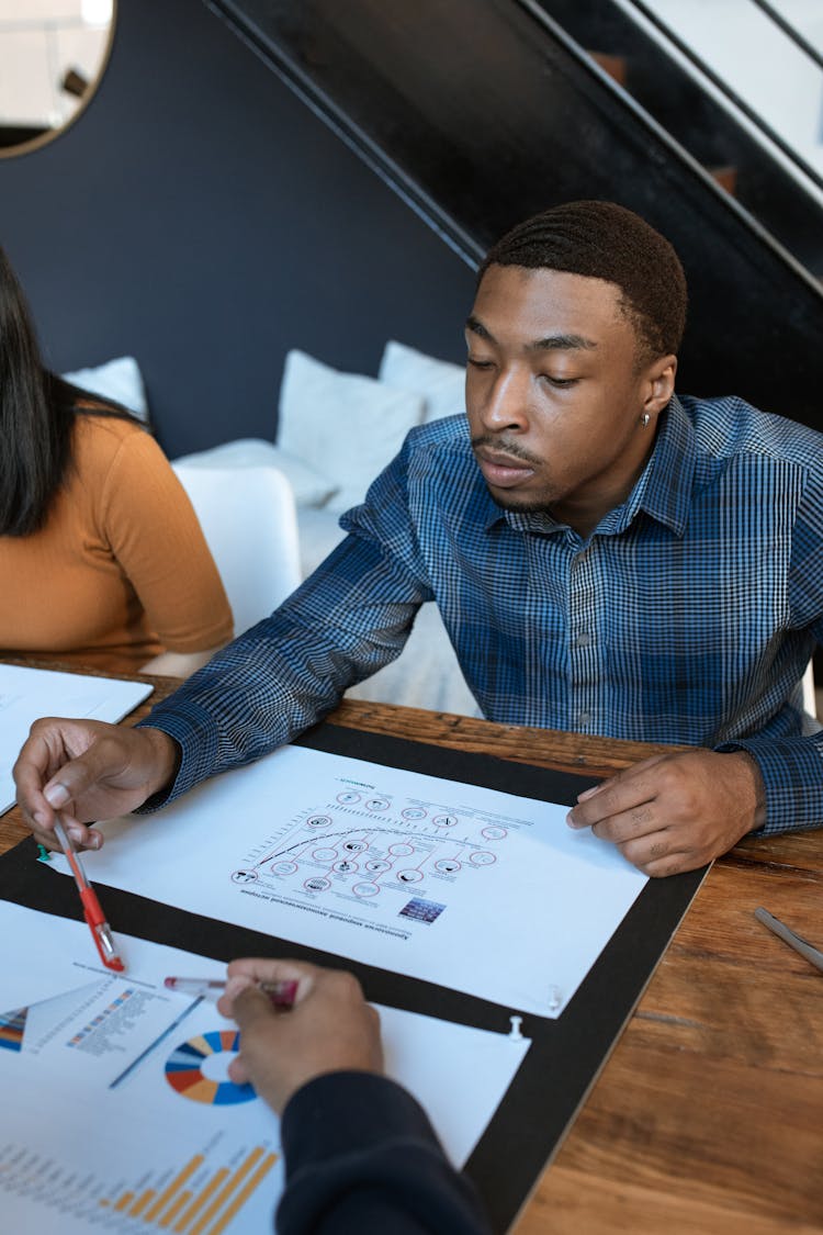 Focused Professional Looking At A Data 