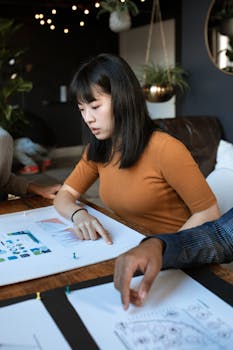 Young woman engaged in work at a creative office space with design documents.