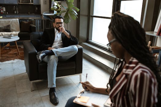 A man and woman engaged in an interview in a stylish modern office.