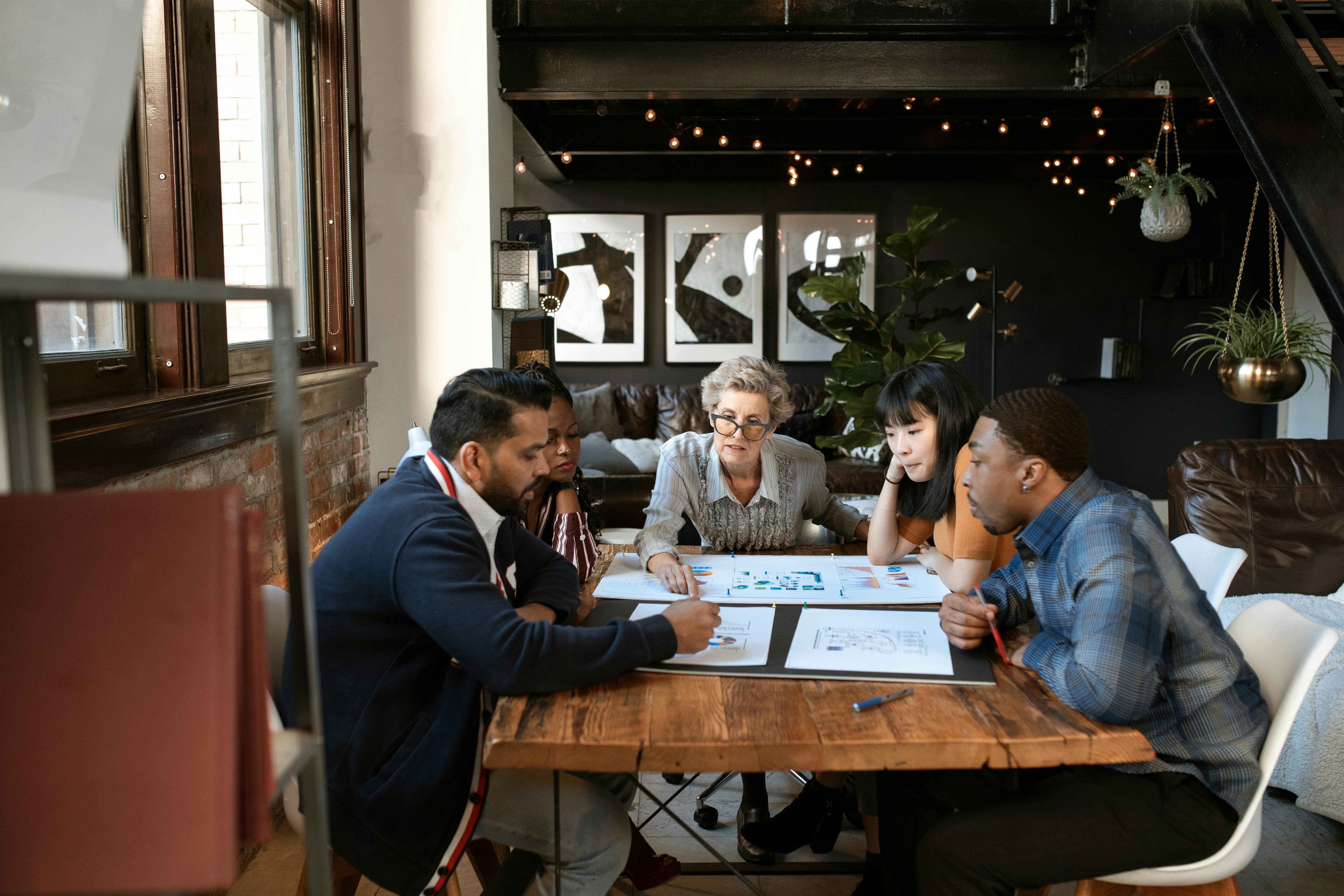 people in a meeting discussing documents