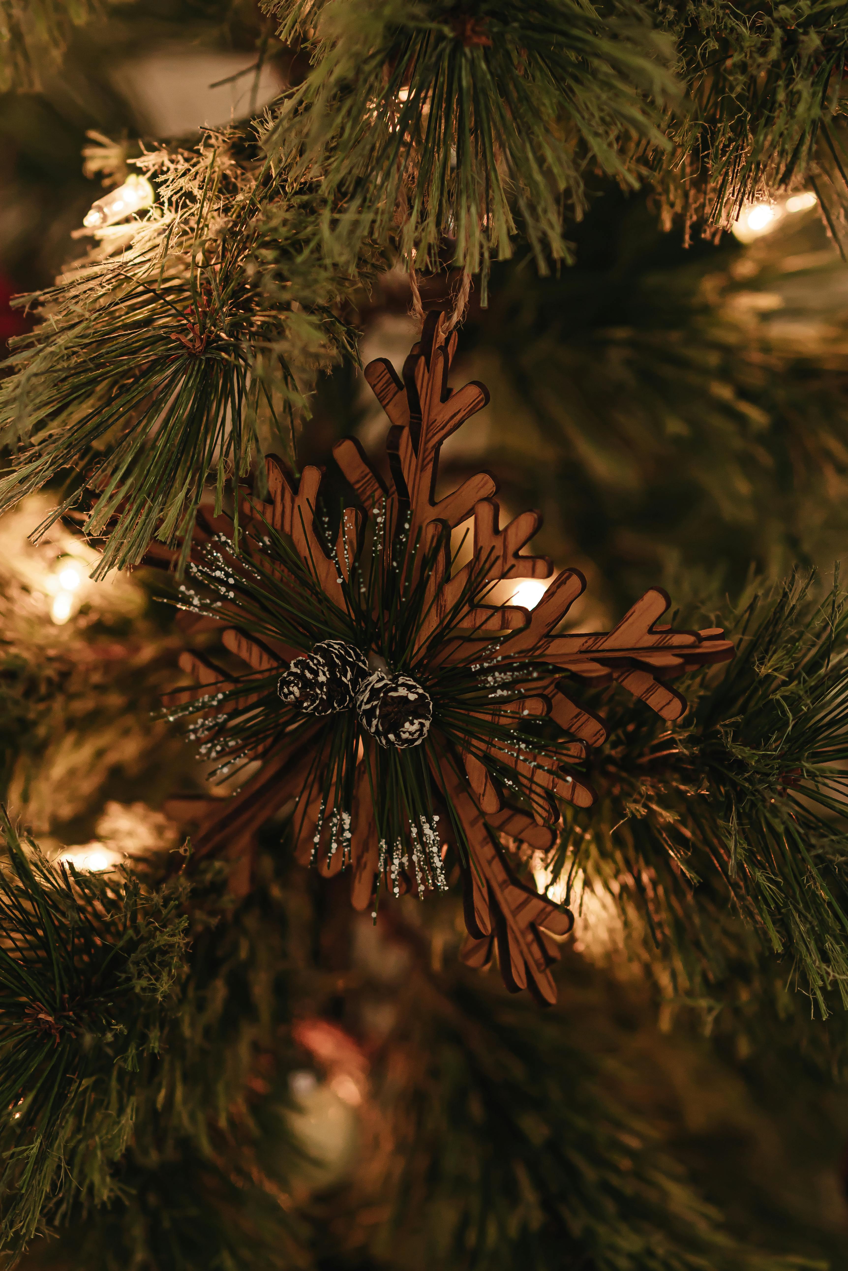 christmas tree decorated with wooden snowflake bauble and garlands