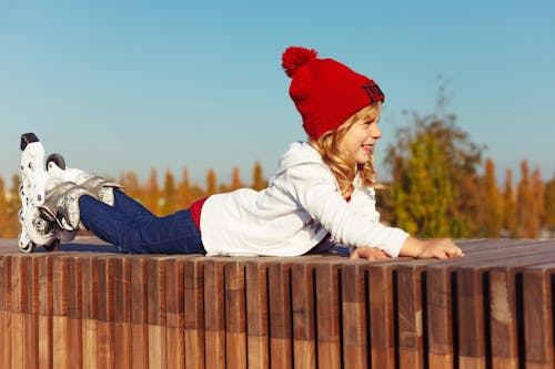 A Girl in White Jacket and Red Beanie