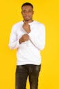 Man in White Shirt Standing on Yellow Background