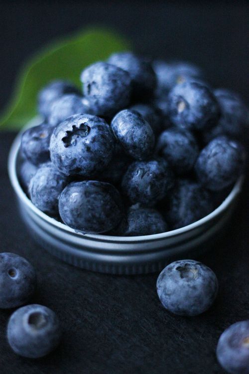 Free Fresh blueberries presented in a small bowl on a dark textured background, highlighting their vibrant color. Stock Photo