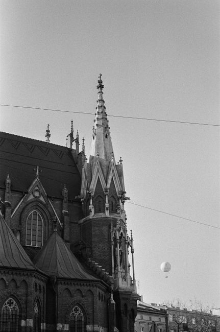A vintage black and white photo of St Joseph's Church, showcasing its intricate gothic architecture in Krakow, Poland.