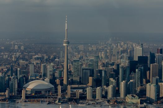 Modern multistage residential and office buildings located around CN Tower in city downtown of Toronto