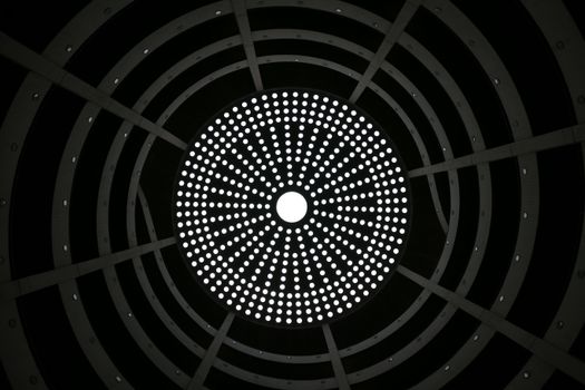 Artistic circular pattern in a modern ceiling with symmetrical light design from Hamburg.