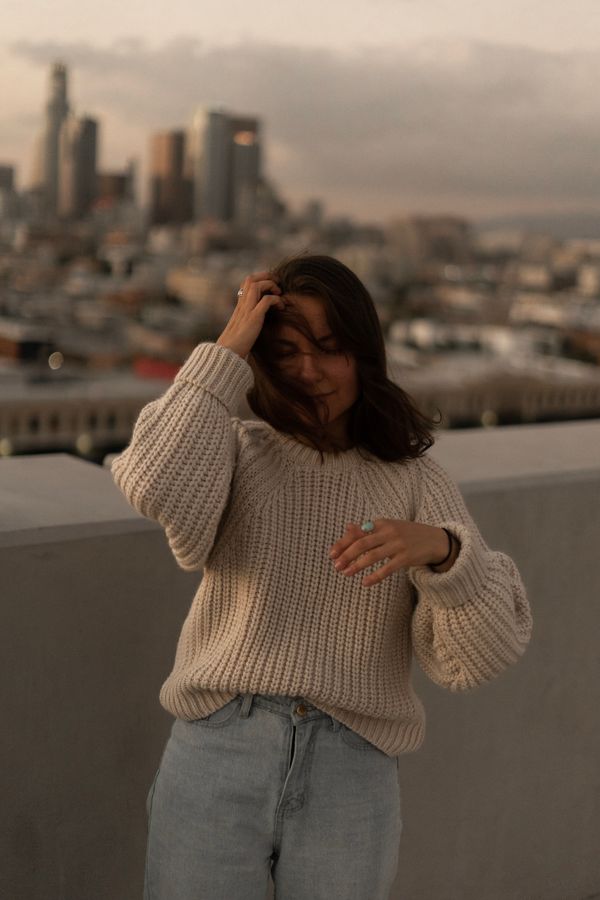 Woman in dark jeans with chunky knit sweater