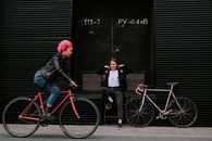 Woman Riding a Red Bicycle