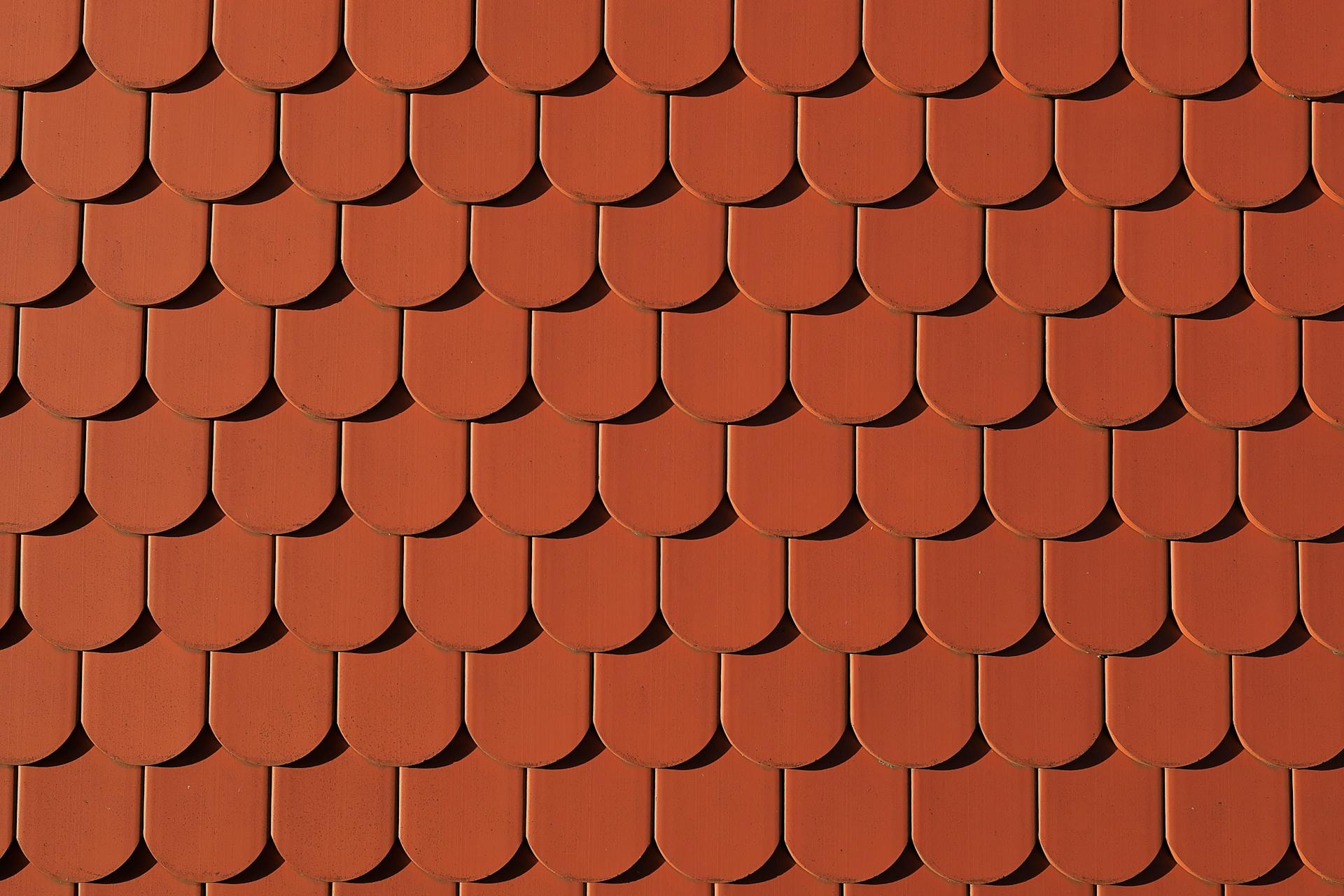 Close-up of red roof tiles creating a uniform pattern, architectural detail.