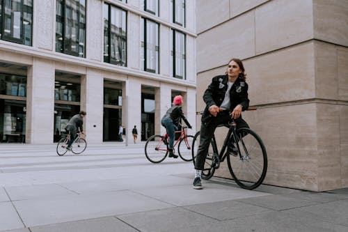 Free Woman in Black Jacket and Black Pants Riding on Black Bicycle Stock Photo